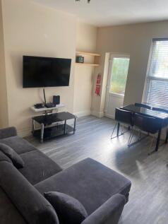 Bright, modern living room with a comfortable g...