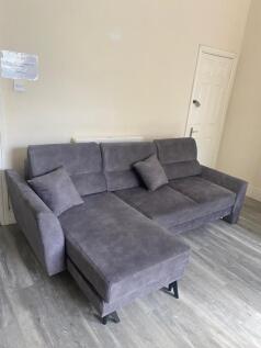 Bright, modern living area featuring a large gr...