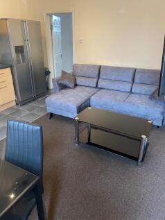 Modern open-plan living area with a grey L-shap...