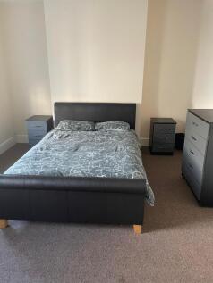 Well-presented bedroom with a comfortable uphol...