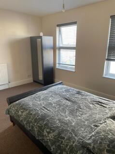 Bright, well-kept bedroom with a double bed, sl...