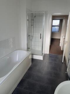 Bright, modern bathroom with a separate walk-in...