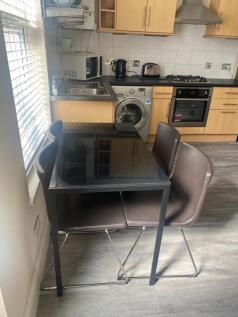 Bright modern kitchen with integrated oven, gas...