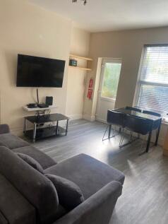 Bright, modern living room with a large grey se...