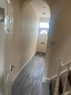 Bright, narrow hallway with fresh-looking pale ...