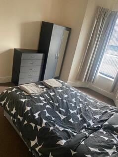 Bright, simply furnished double bedroom with a ...