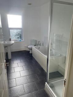 Bright, modern bathroom with a separate shower ...