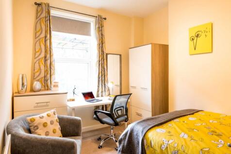Bright, cosy bedroom with a cheerful yellow duv...