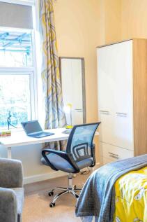 Bright, modern bedroom with a study area by a l...