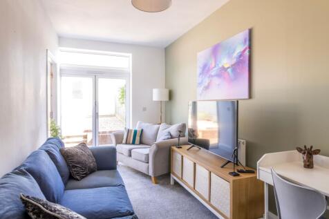 Bright, modern living room with comfortable sea...