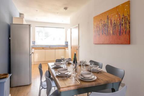 Bright, modern kitchen-diner with a wooden dini...