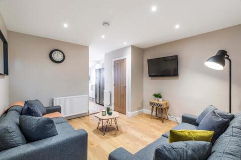 Bright, modern living room with comfortable sof...