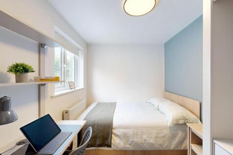 A bright and welcoming master bedroom featuring...