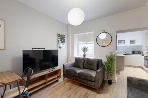 A bright and welcoming living room featuring a ...