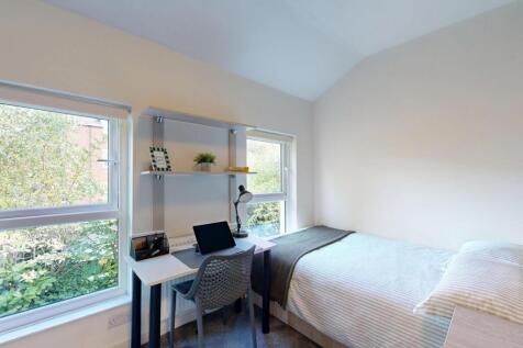 A bright and tidy single bedroom with a comfort...