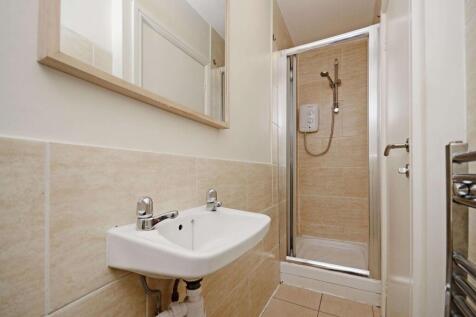 Well-maintained bathroom with modern tiled wall...