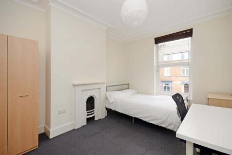 Bright, simply furnished bedroom with a double ...
