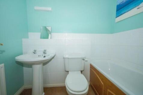 Bright bathroom with a classic white pedestal s...