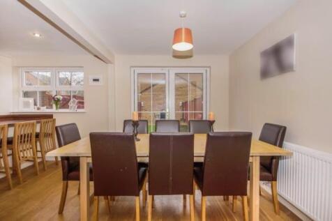 Bright, modern open-plan dining area with a woo...