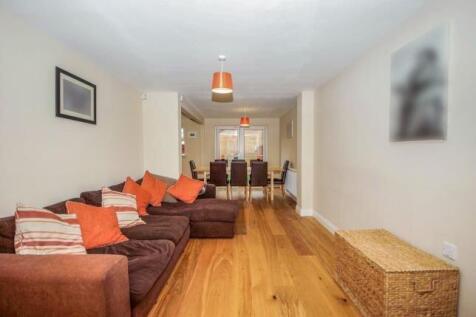 Bright, open-plan living and dining area with w...