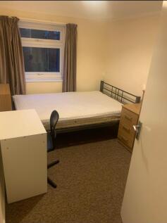 A cozy double bedroom featuring ample natural l...