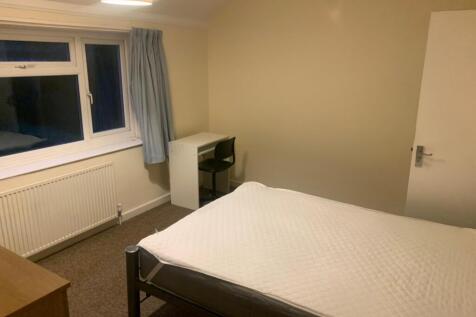 A spacious and well-lit double bedroom, perfect...