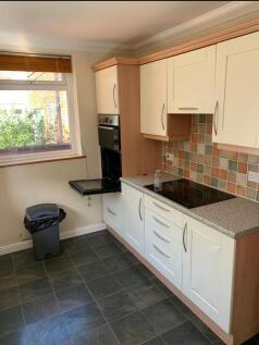 A bright and tidy kitchen with modern cabinetry...