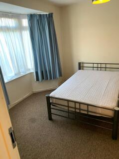 A bright and tidy double bedroom featuring larg...