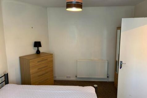 A bright and tidy double bedroom featuring a st...