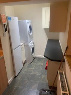 A functional kitchen space with essential appli...