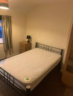 A cozy and inviting double bedroom with ample s...