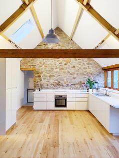 Bright, contemporary kitchen with white cabinet...