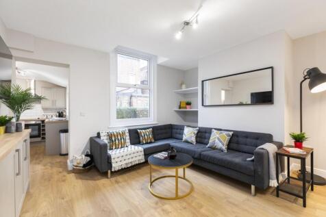 Bright, modern living area with ample natural l...