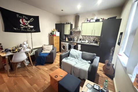 A bright and welcoming living room featuring co...