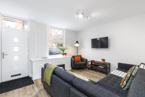 Bright, contemporary living room with a large L...