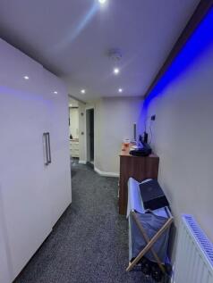 Modern carpeted hallway with recessed ceiling l...