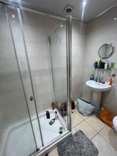Modern bathroom with a glass-enclosed shower cu...