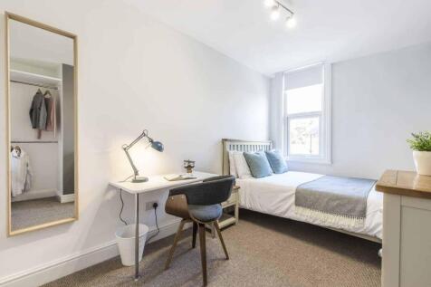 Bright, neatly presented bedroom with a comfort...