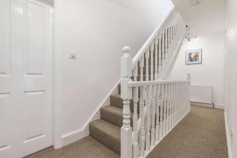 Bright, well-maintained carpeted staircase and ...
