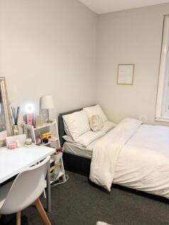 Bright, tidy bedroom with a comfortable bed, co...
