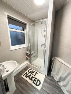 Modern bathroom with walk-in shower, pedestal s...