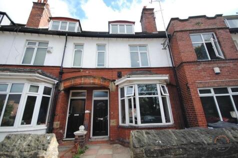 Red-brick terraced house with bay windows and a...