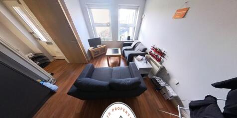 A bright, modern living room featuring comforta...