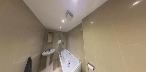 A clean, well-maintained bathroom featuring a l...