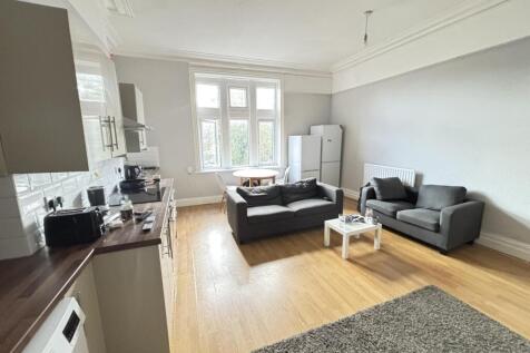 A bright and spacious living room featuring mod...