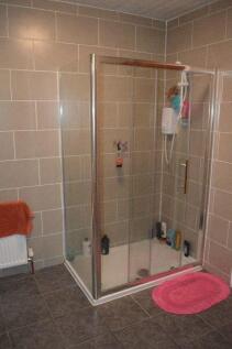 A clean and functional bathroom with a glass sh...