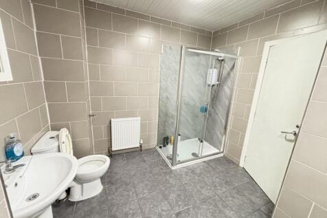 A clean, modern bathroom with a spacious shower...