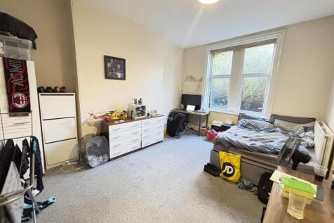 A bright and welcoming living room with large w...