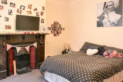 Cozy bedroom with a double bed, decorative fire...