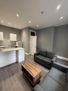 A modern and well-lit living room featuring a c...